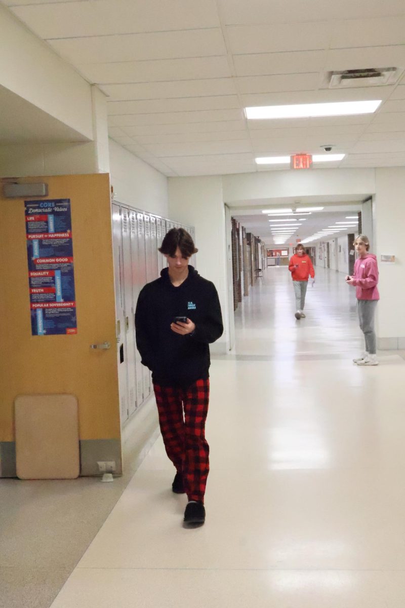 Walking back to class, junior Evan Hoglin shows off his participation for the spirit week. On Feb. 5, FHS holds a pj day in preparation for the snow ball. 