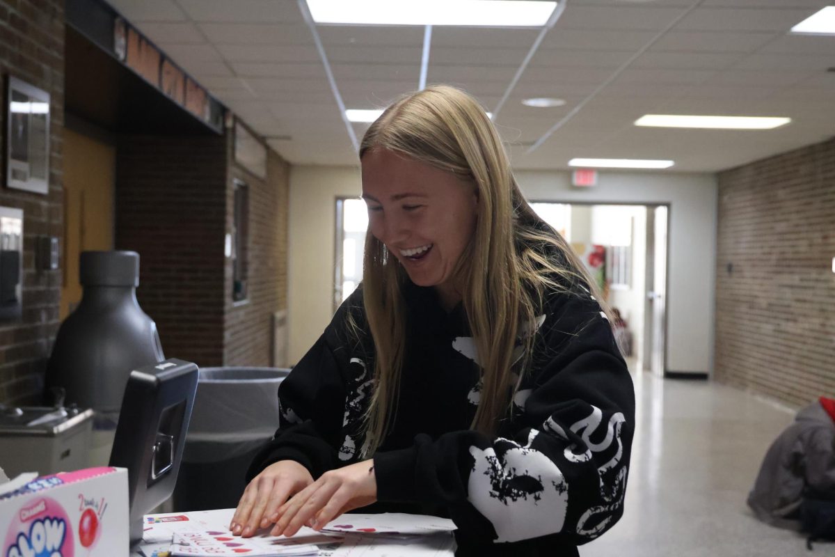 Helping the yearbook, Senior Shea Temrowski hands out valentines grams. On Feb. 12, the Fenton yearbook staff sold valentines grams to raise money. 