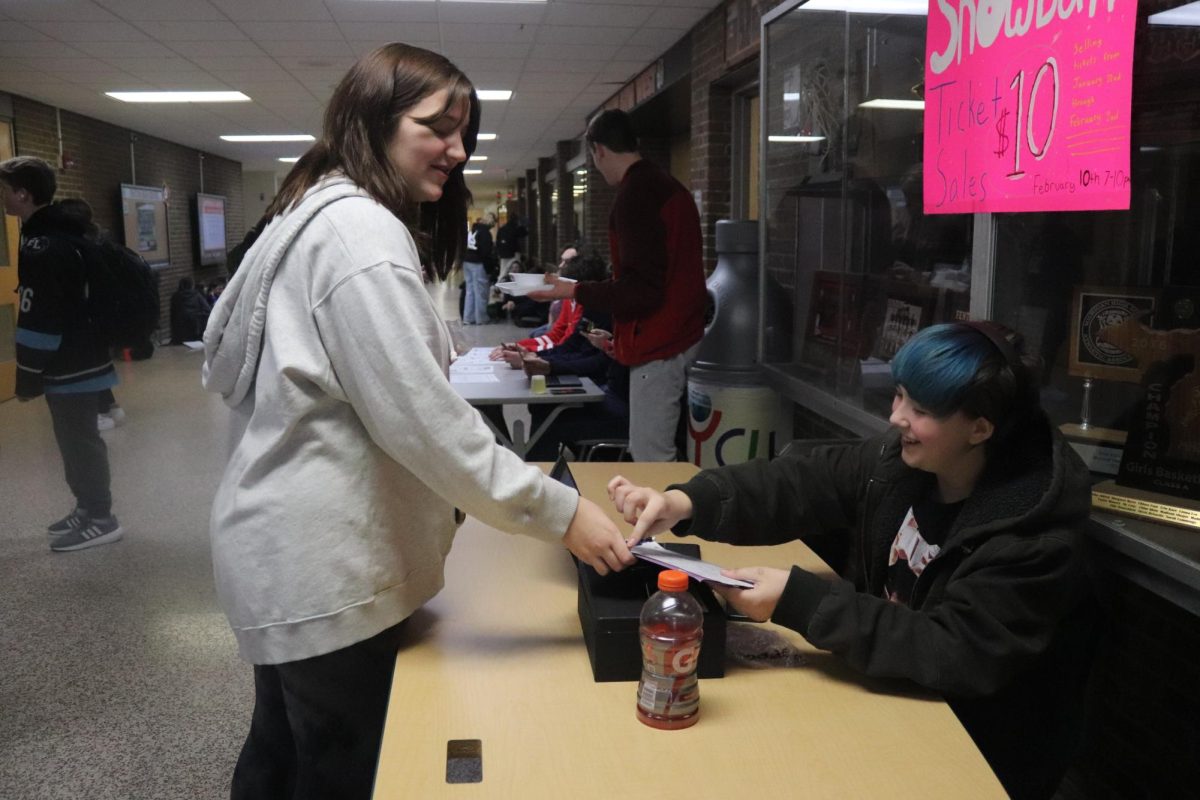 Helping, freshman Ellliot Green works the ticket table. On Jan, 31. student council sold dance tickets to students. 