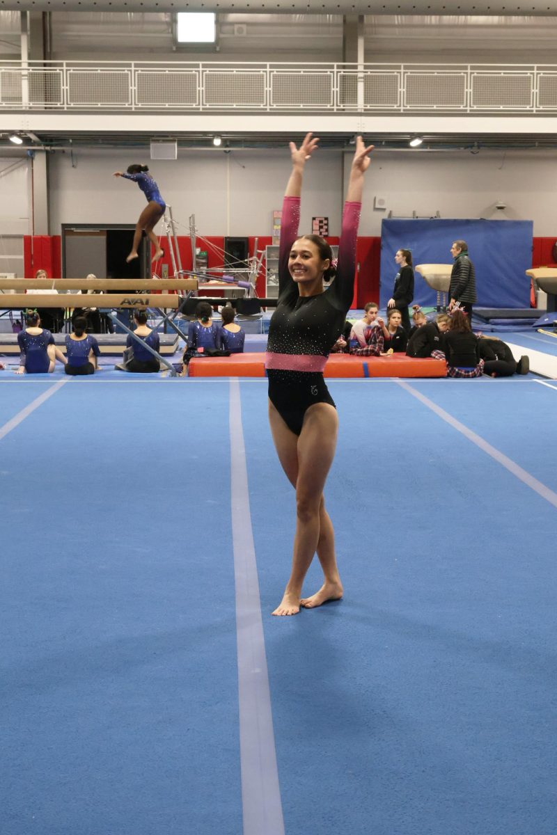 Saluting to the judge, Senior Jillian Shanahan finishes her floor routine. On Feb. 17 the LFLF gymnastics team held a competition and won.   