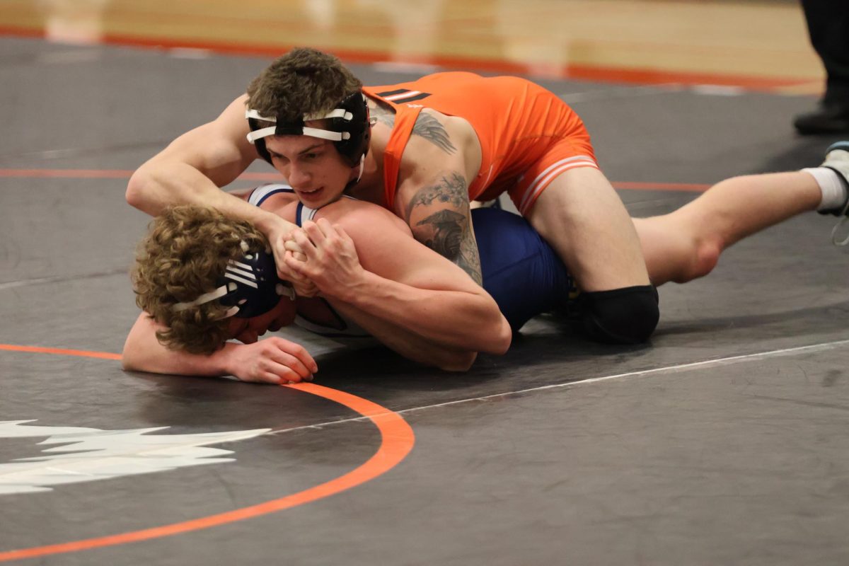 Wrestling, junior Kaleb Digiacomo is on top of his opponent. On Jan. 27, the FHS wrestling team hosted a tournament in the main gym.