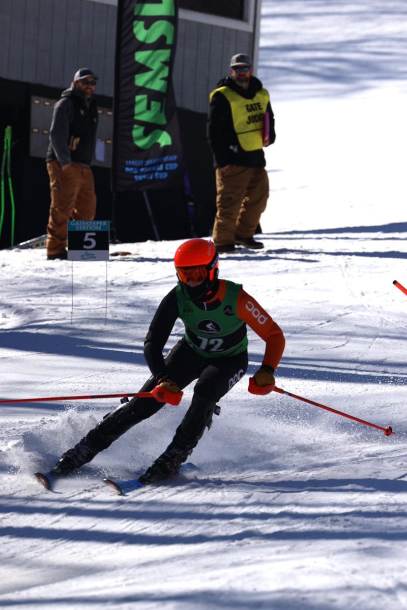 Skiing senior Shane Hindmon goes down the slope. On Feb. 20, the FHS boys and girls ski team participated in the SEMSL championship at Alpine valley.