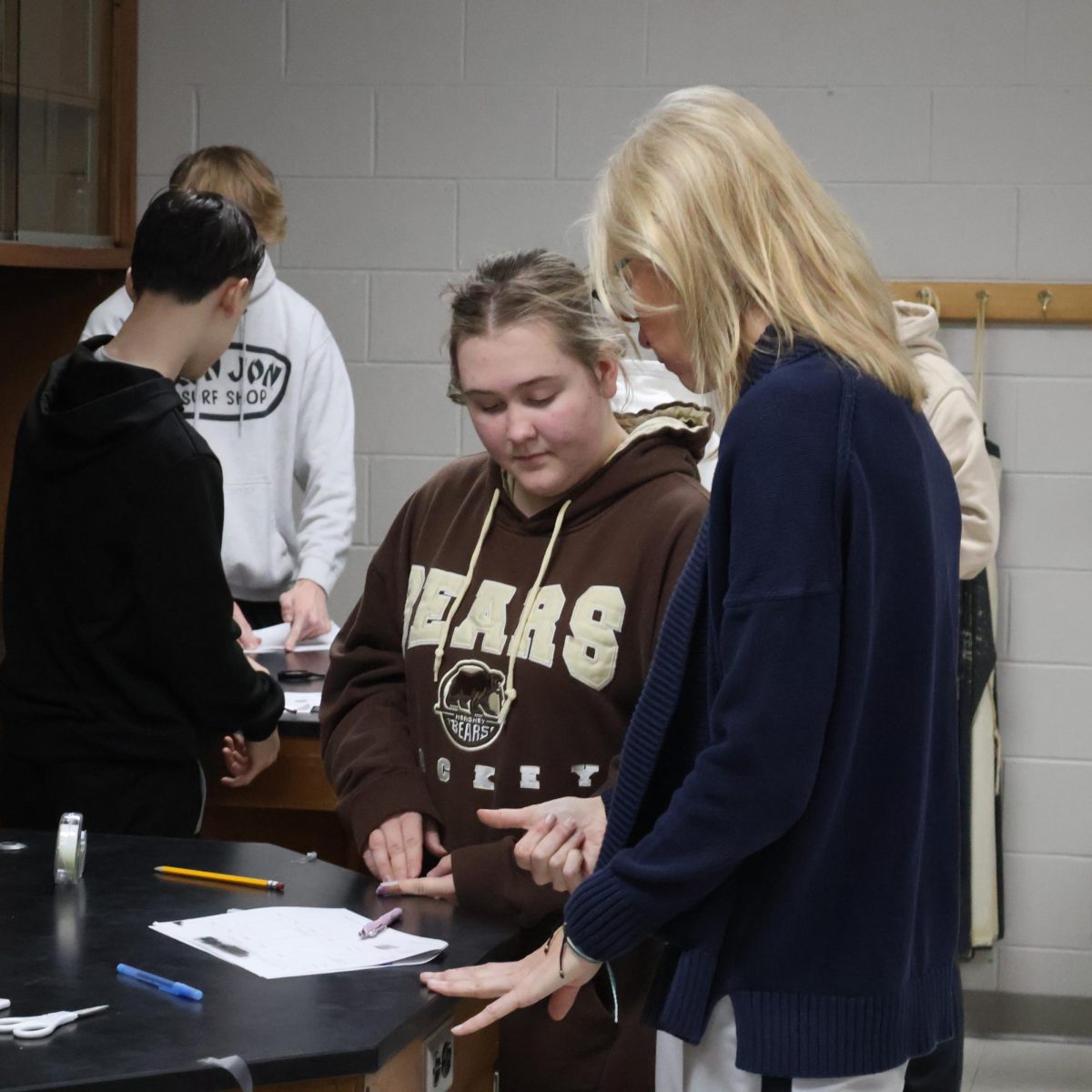 Standing, Freshman Abigail Emery gets help from Mrs. Thomas. On March 7, teacher Leah Thomas had a fingerprint lab with her third hour.