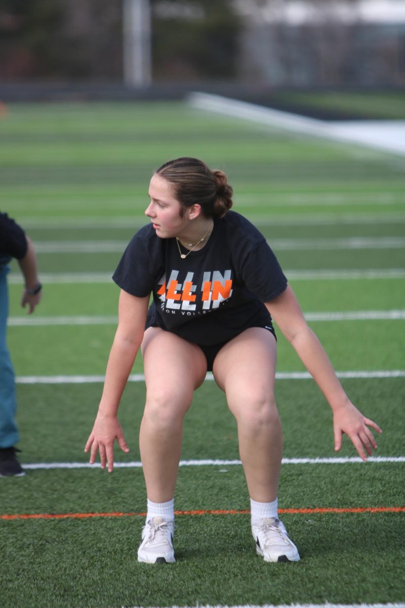 Mid squat, sophomore Grace Perry participates in the girls lacrosse training. On March 7, the Heat lacrosse team held a speed and agility practice. 