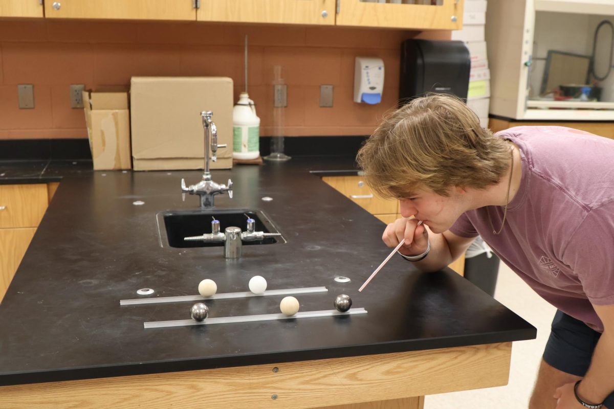 Blowing spheres, sophomore Hayden Weaver participates in Mr. Kasaks Lab. On March 3, the sophomores in physical science did a inertia lab.