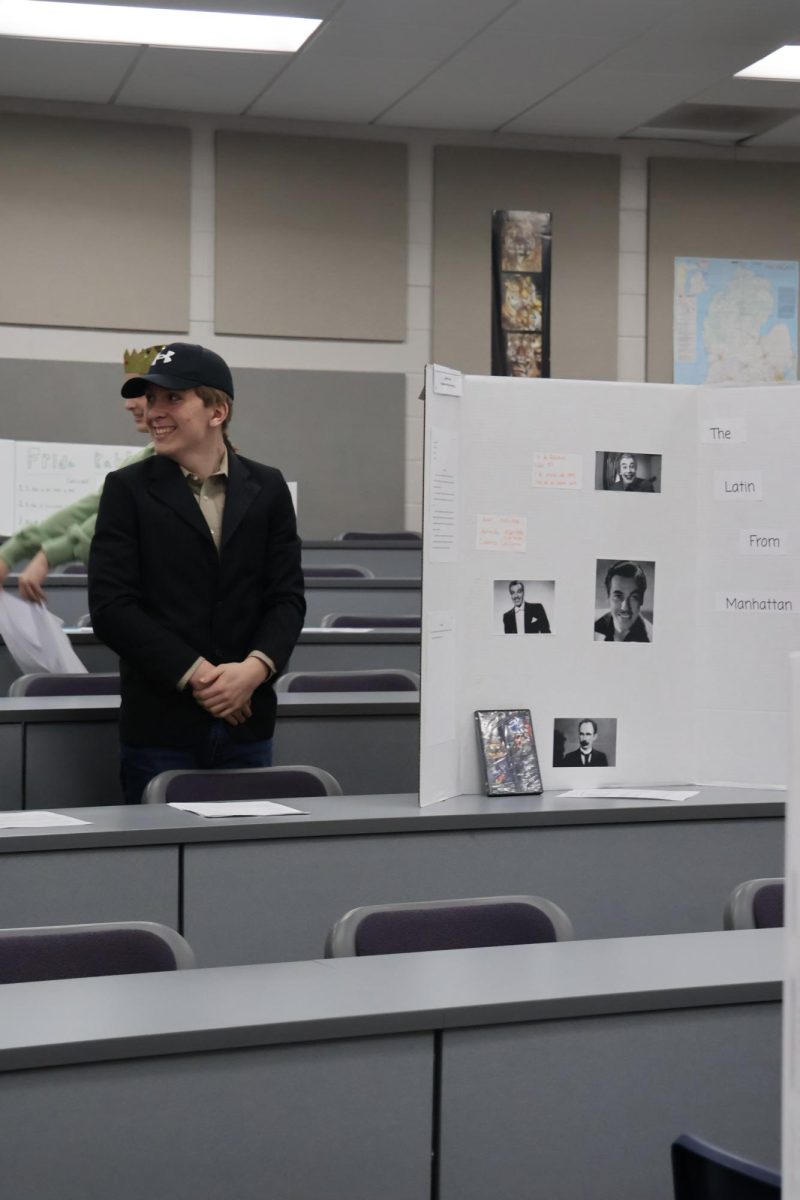 Smiling, Chris Ladd waits for a classmate to unfreeze him. On March 20, the spanish 2 class had a wax museum. 