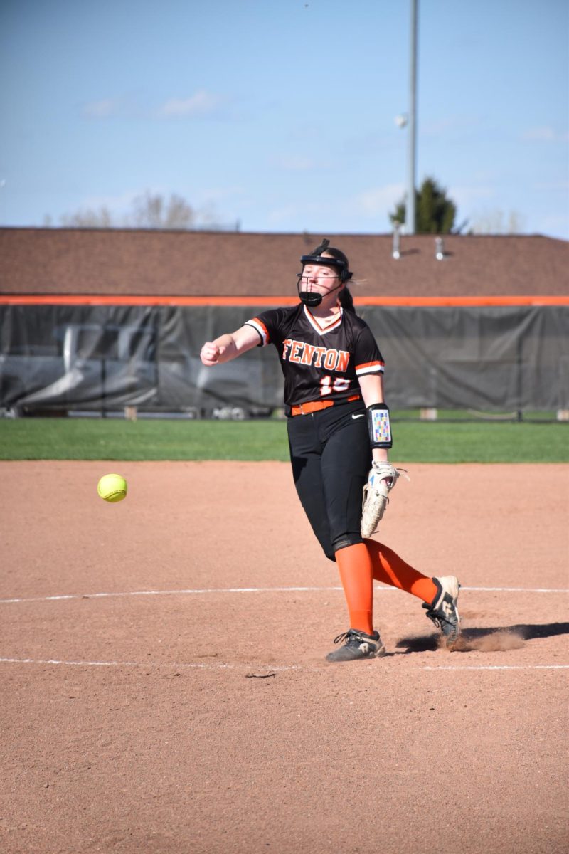 Throwing the ball, junior Zoe Plunkett attempts to strike out the opponent. On Apr. 15, the JV softball team played Holly and won 15-0 and 18-0 in their games.