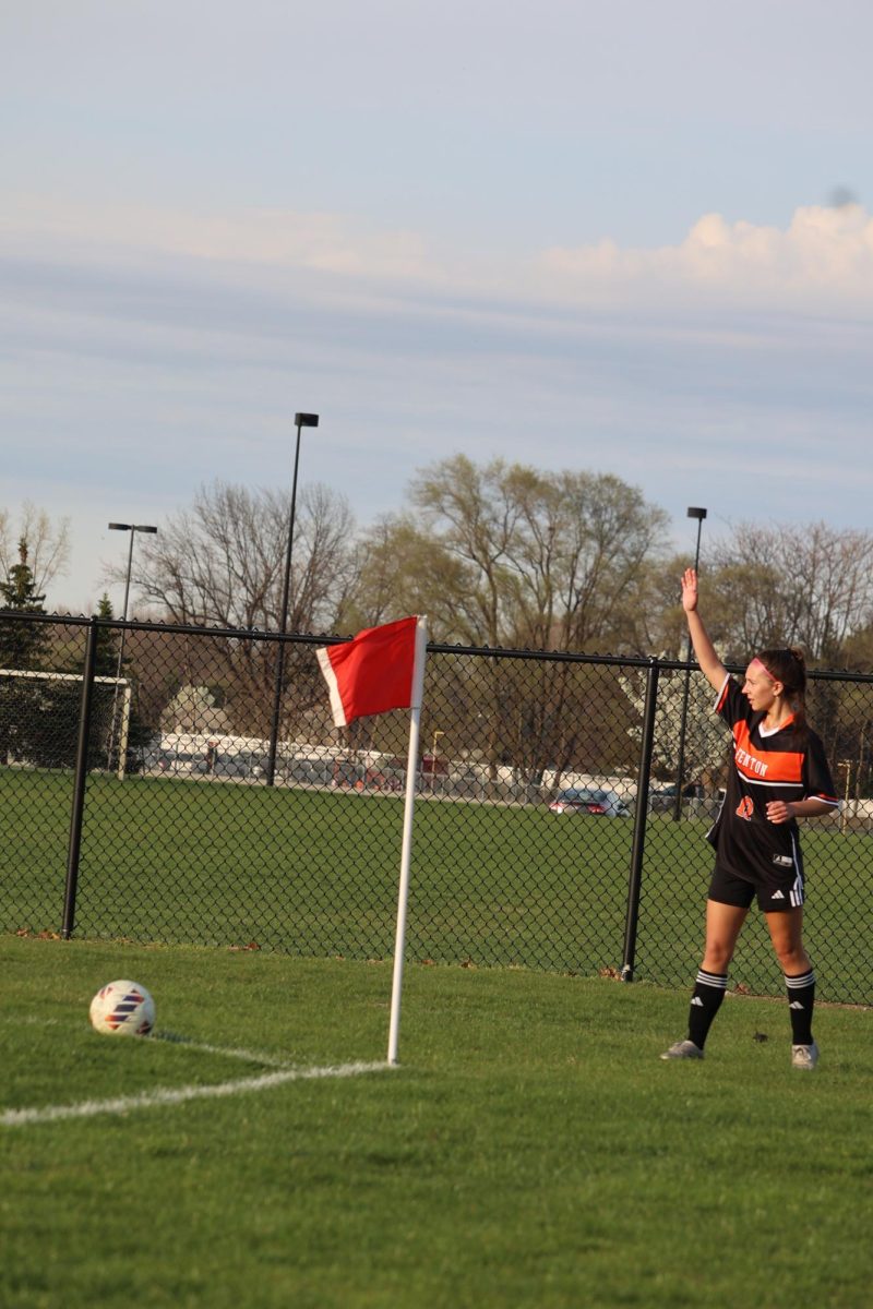 Setting up for a corner kick, freshman Anna Koscielniak passes the ball to her teammates in the goalie box. On April 16, the Fenton girls jv soccer team played Livonia Stevenson. 