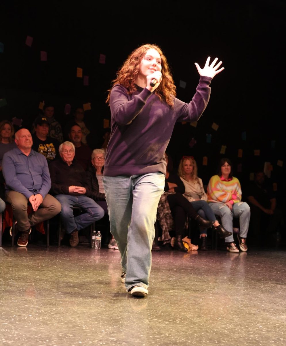 Performing Every Brilliant Thing, junior Bella Butzine interacts with the audience. On Apr. 12, IB theater performed their last play that would be directed by teacher Lori Thompson.