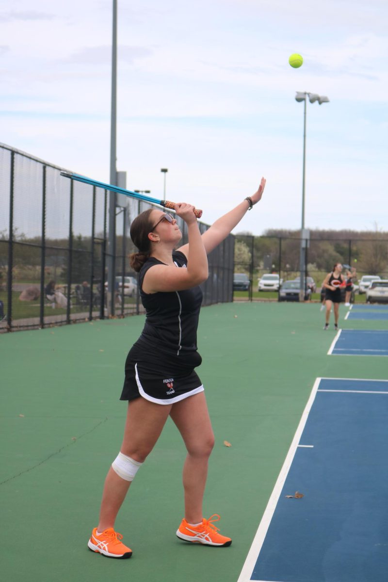 Swinging, junior Ruby Wojtaszek looks at the ball, On April 18, the FHS girls varsity tennis team competed against Clio.