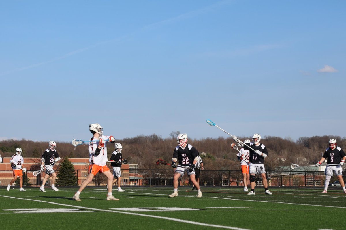 Passing, senior Grant Hayden throws the ball to his teammates. On April 9, Fenton boys lacrosse won against Swartz Creek with a score of 9-8. 