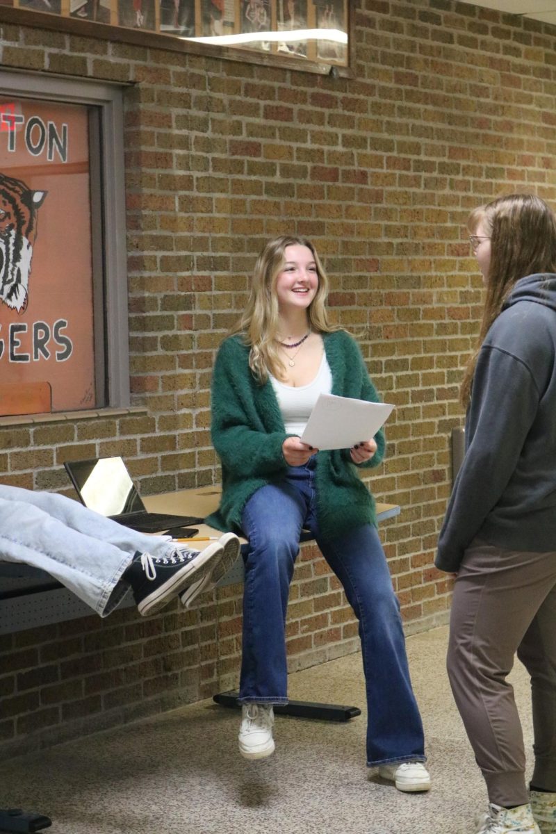 Smiling, sophomore Lily Underwood works with her group. On Apr. 12, the AMS class filmed videos for their social commentary projects.