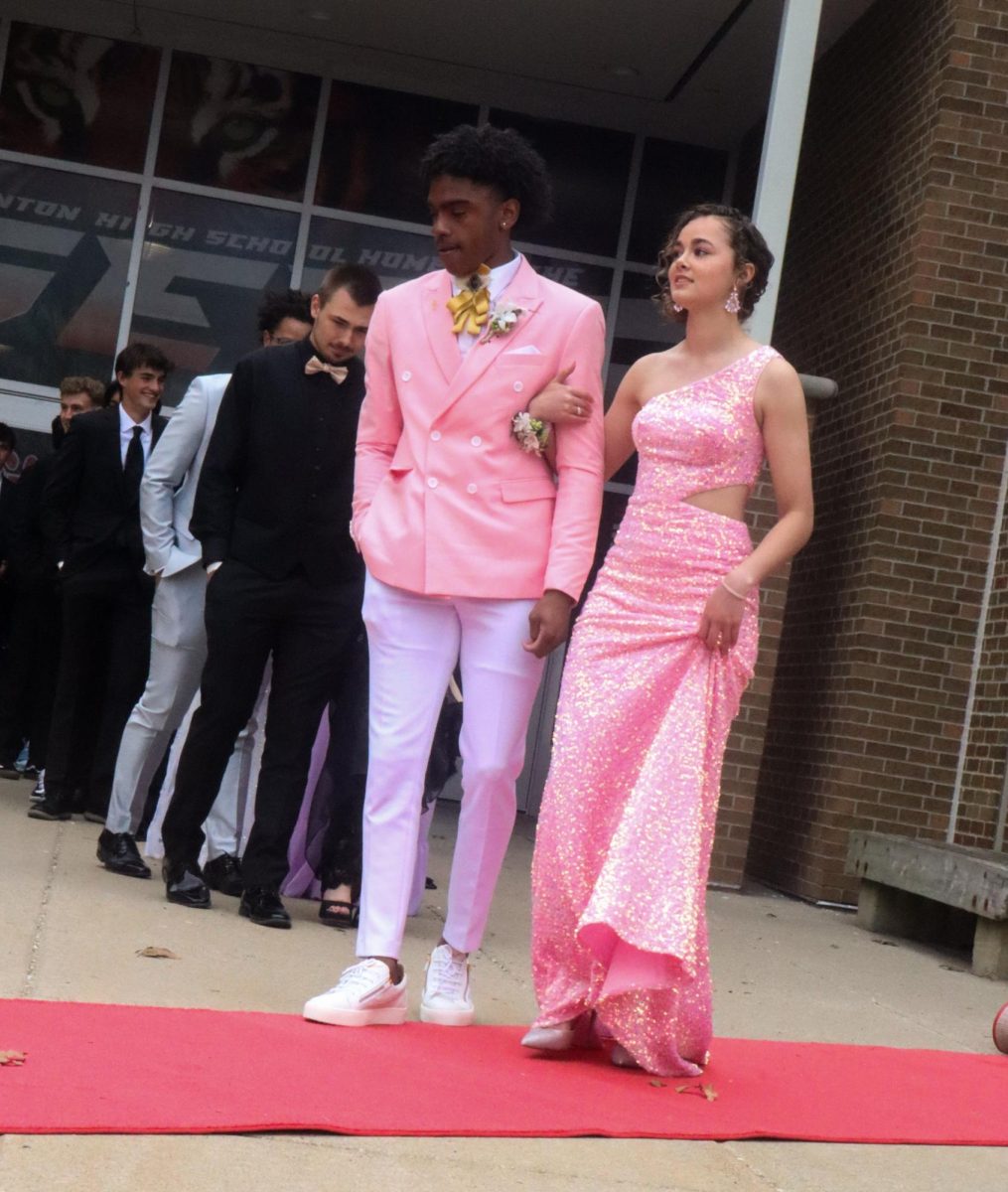 Waiting, Laila Blackwell and Ja'Hion Bond walk the red carpet. On April 20, upperclassmen showed off their Prom attire before attending the formal. 