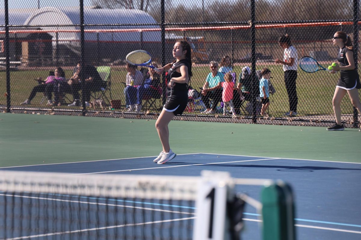 Looking, sophomore Fernanda Gonzalez-Hernandez hits the ball. On April 16, the FHS girls varsity tennis team went up against Swartz Creek.
