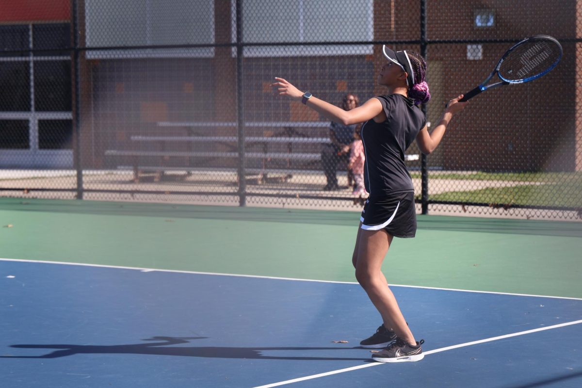 Swinging, sophomore Kierstyn Rutley looks at the ball. On April 16, the FHS girls varsity tennis team competed against Corunna.