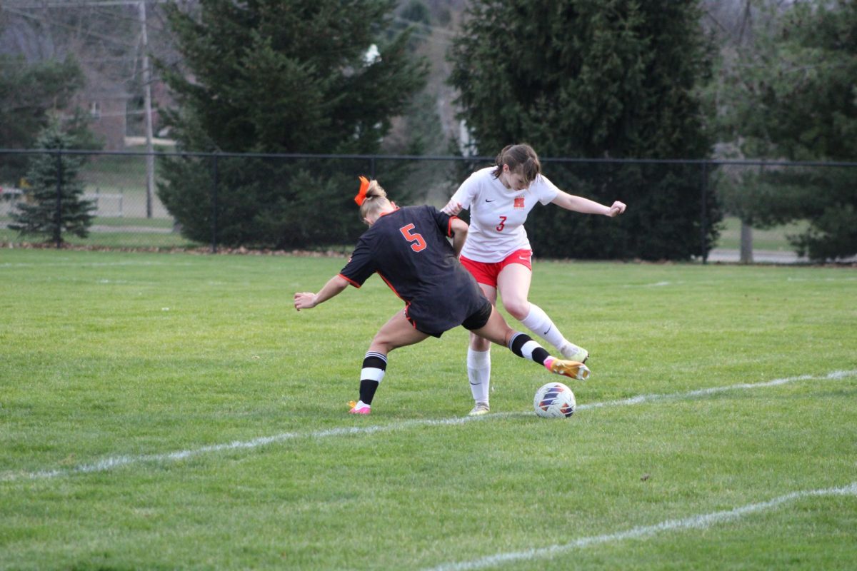 










Attempting to get the ball, junior Lydia Klemish tries to keep the ball in bounds. On Apr. 10, the varsity soccer team played Holly tying 1-1.