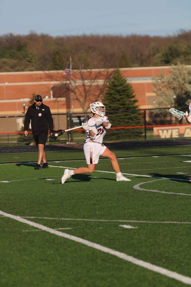 Shooting, sophomore Nathan Fuller attempts to score a goal. On April 19, the Fenton lacrosse team played against the Linden eagles and won 17-3.