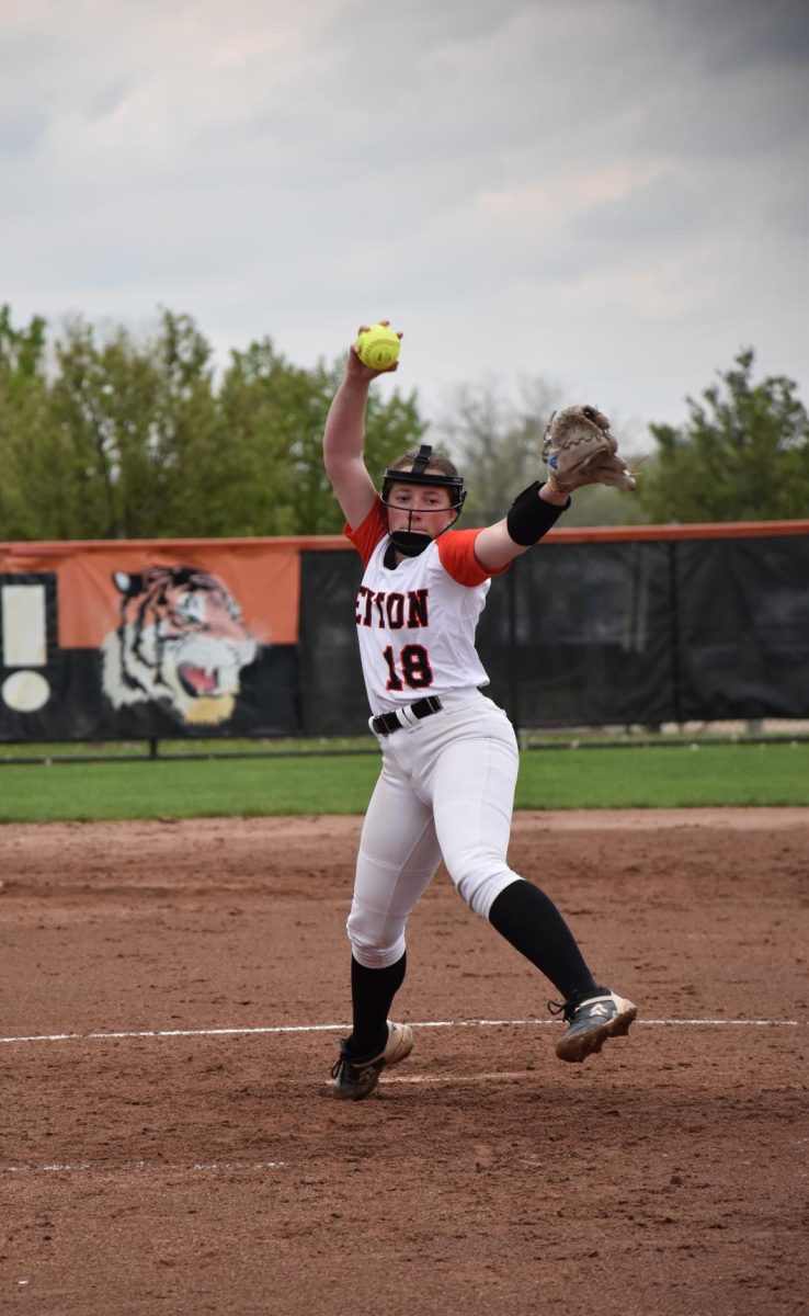 Throwing the ball, junior Zoe Plunkett pitches in a recent game. On May 3, the JV softball team beat Regina.