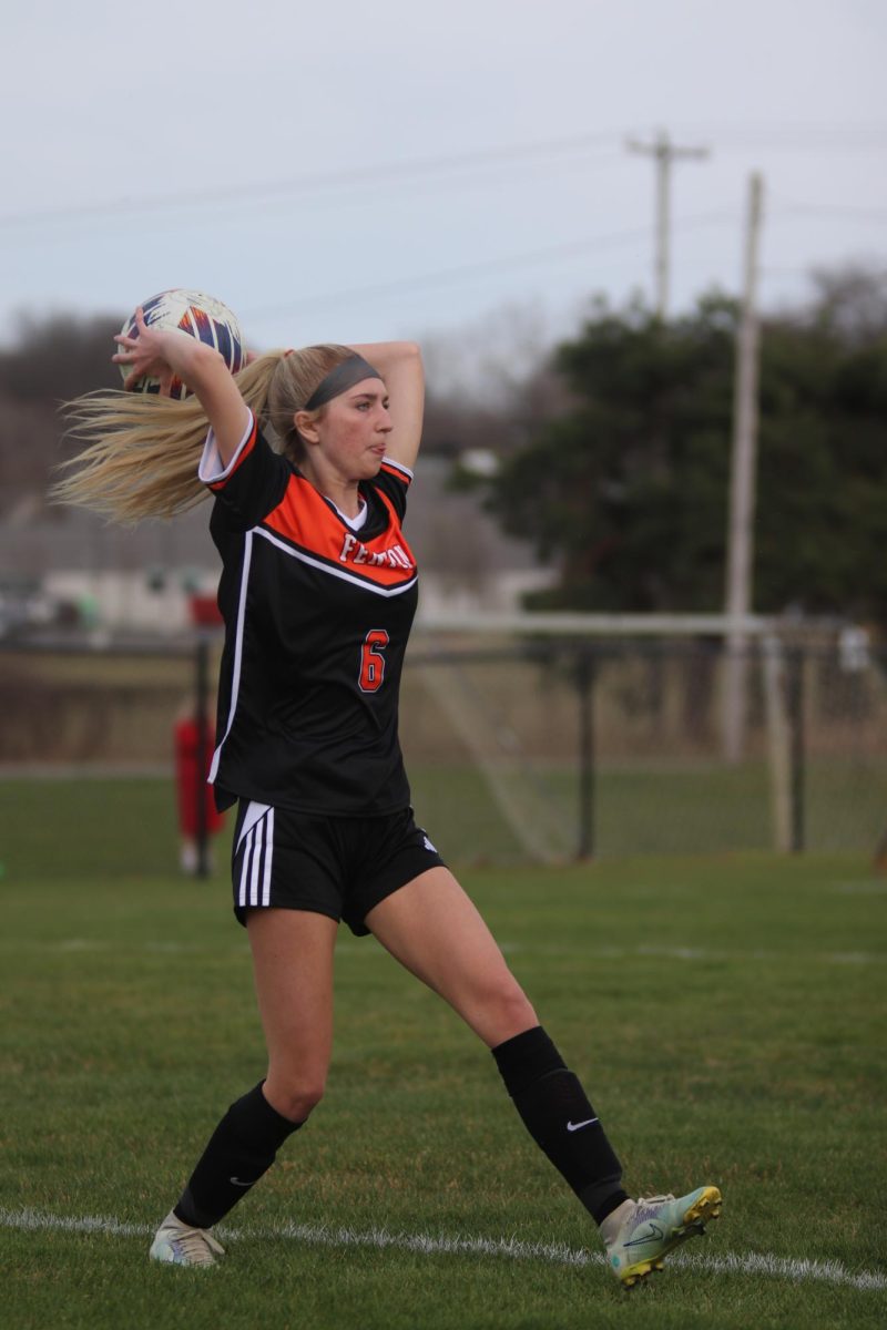 In stance, Grace Carpenter gets ready to throw the ball. On April 10, the JV girls soccer team played Holly at home.