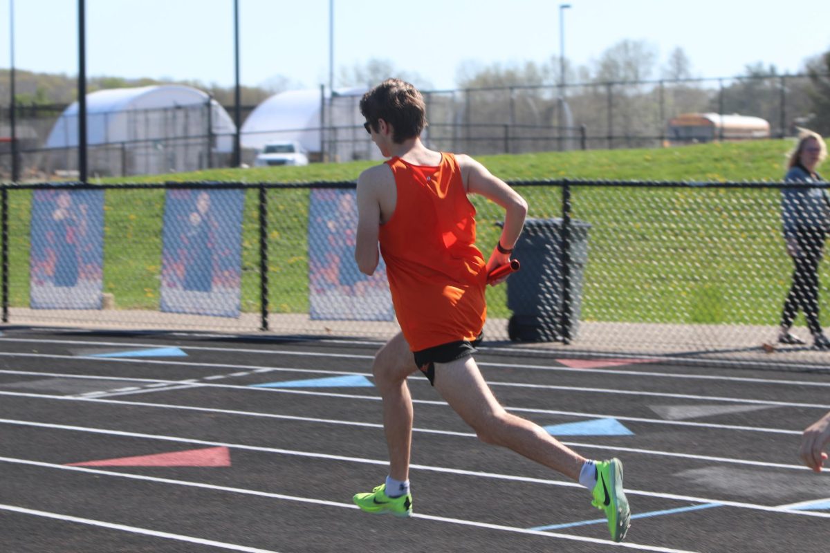 Running, Senior Anthony Maini runs the first leg of the 4x800 relay. On May 1, the boys track team went up against Holly and won 98-30.