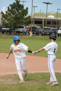 High-fiving, freshman Madden Shaman and Kavaun Gregory celebrate a good play. On May. 2, Fenton freshman baseball went up against Detroit Catholic Central HS in a double header. 