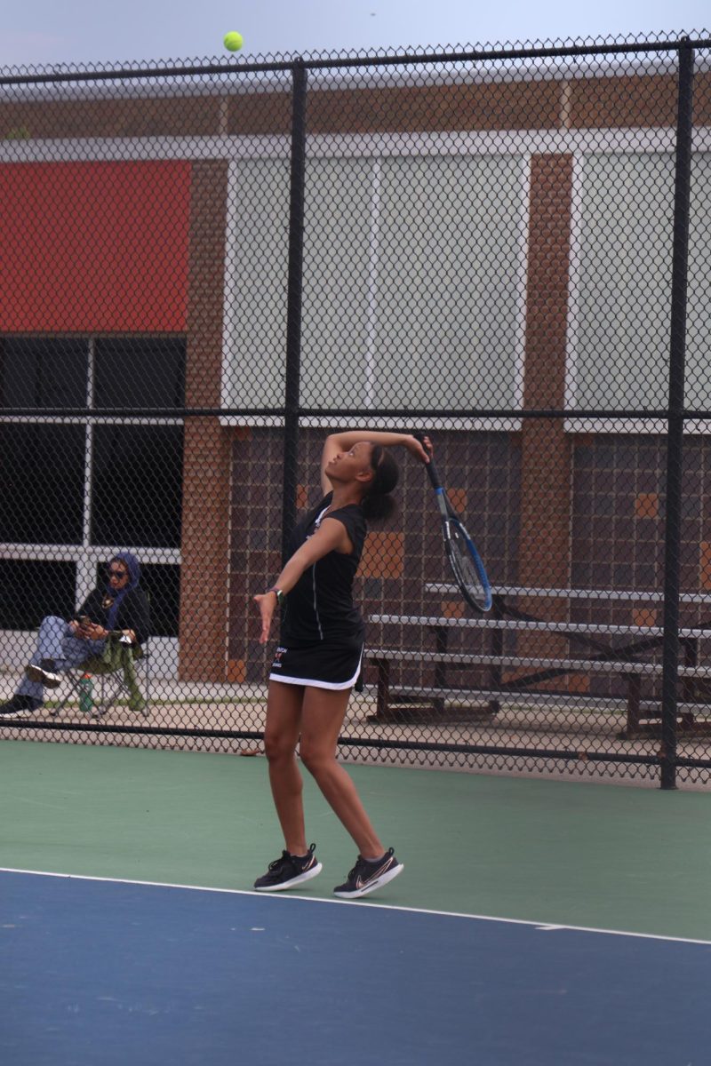 Looking, sophomore Kierstyn Rutley swings. On May 2, the FHS girls varsity tennis team went up against Flushing.