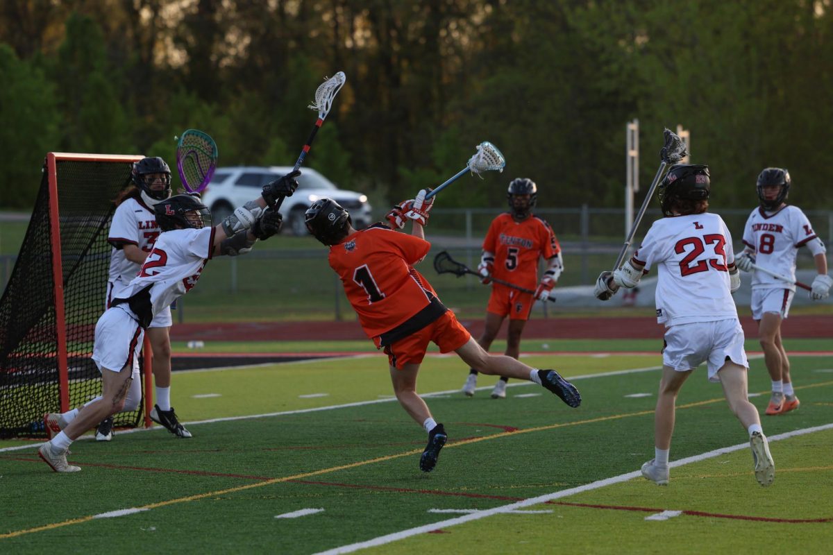 Jumping with the ball, Owen Mueller attempt to score. On May 7, the Fenton high school boys lacrosse team went up against Linden beating them 6 to 3.