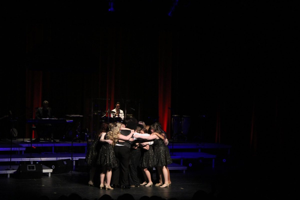 Hugging senior Macy Wright, the Ambassadors celebrate her last solo. On May 11, the Ambassadors held their concert celebrating 45 years.