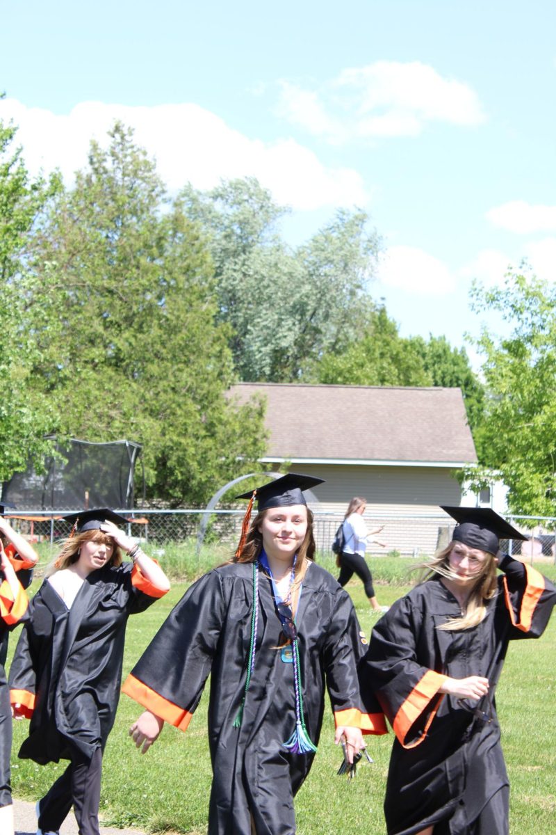 Walking, senior Bella Berger takes a trip around her old elementary school. On May 22, North Road Elementary had a walkout for graduating seniors.