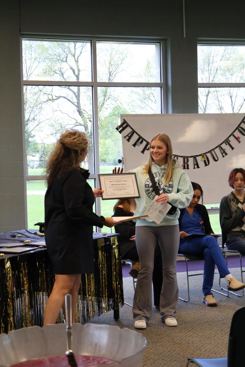 Smiling, class of 2024 graduate Madelynn Hyten receives her diploma. On May 10, Mrs. Boike held an assembly for the Mott senior graduation. 