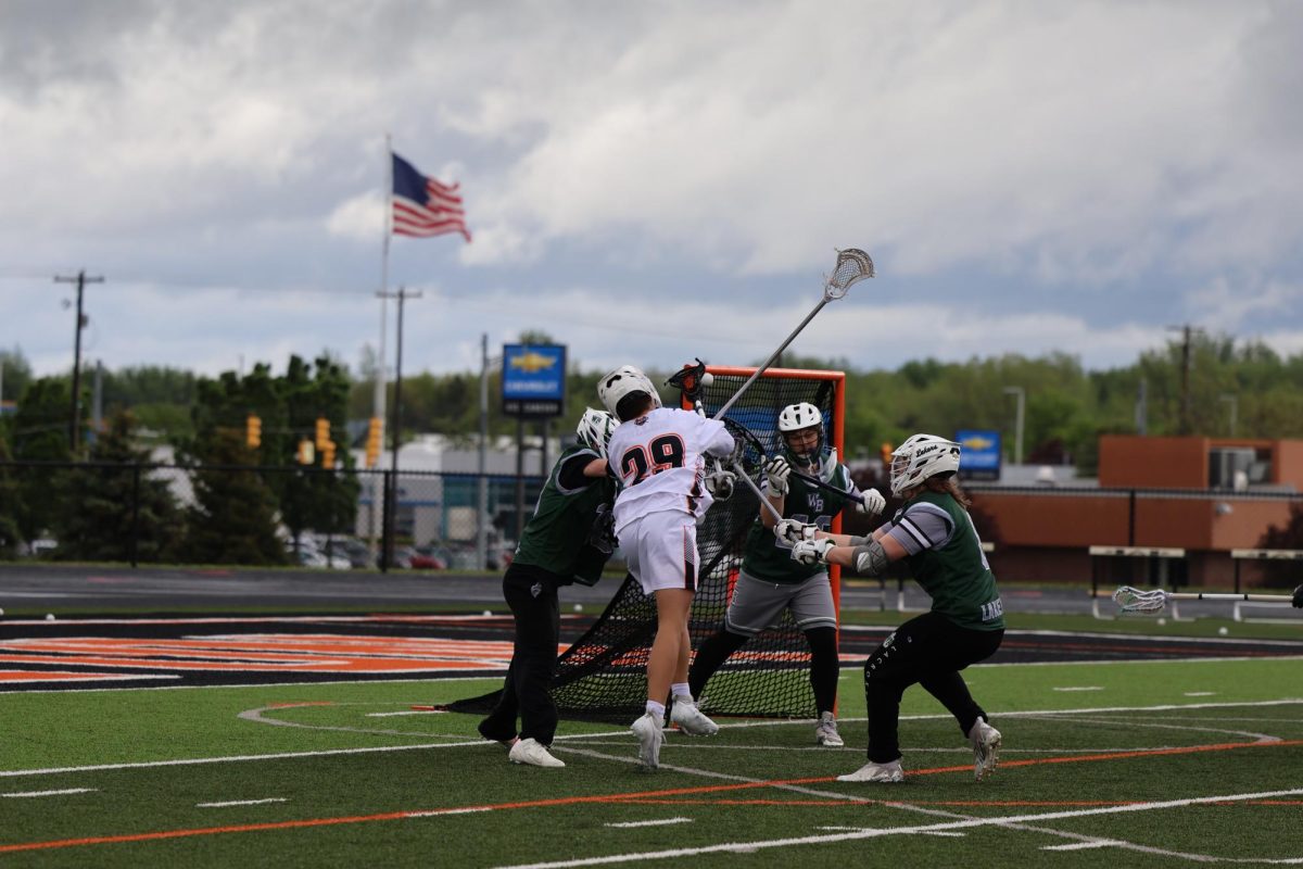Shooting the ball, sophomore Nathan Fuller attempts to score. On May 11, the FHS varsity lacrosse team went up against West Bloomfield beating them 15 to 2.