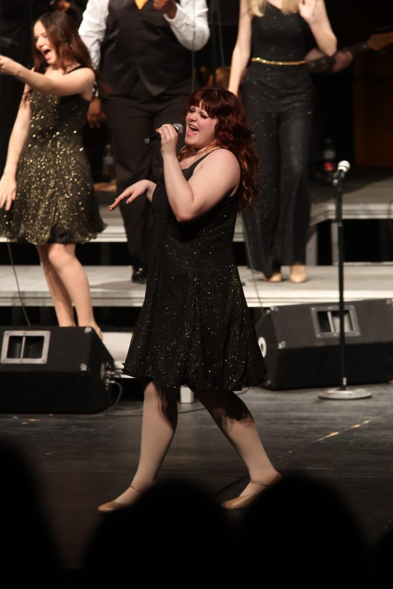 Singing, sophomore Millie Grasso performs. On May 11, the Ambassadors held their 45th concert.