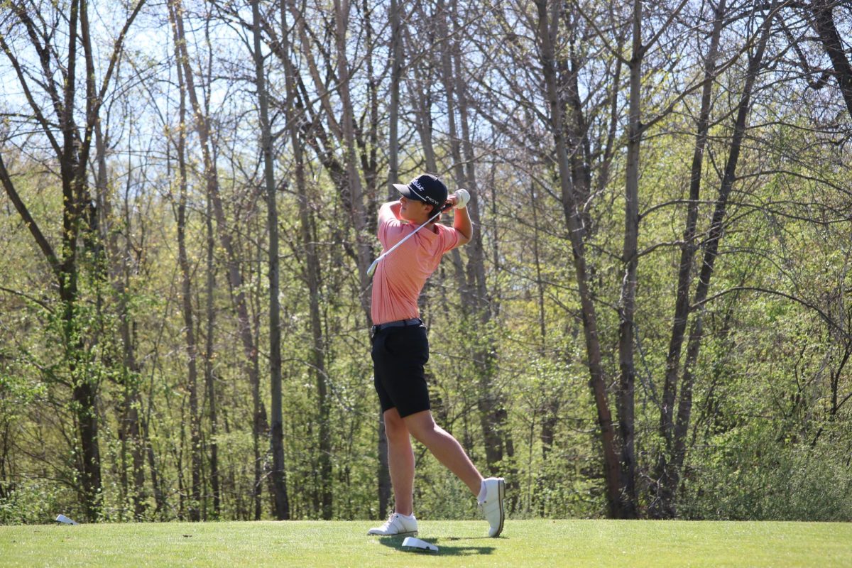Following through, sophomore Preston Muntin tees off of the tee box. On May 1, the Fenton boys varsity golf team played against Linden and won with a score of 176-182.