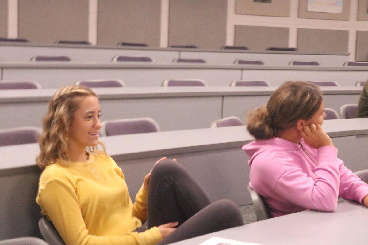 Smiling, freshmen Sage Menzies attends the cross country camp meeting. On May 16, the Fenton cross country coaches held a camp meeting. 