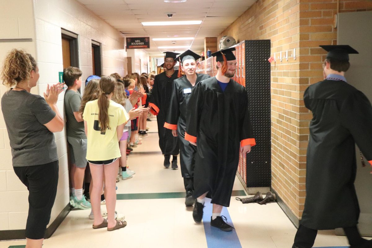 Walking through the hallways, senior Joe Harris and his classmates visit their elementary school. On May 22, the elementary students clapped out the FHS seniors. 