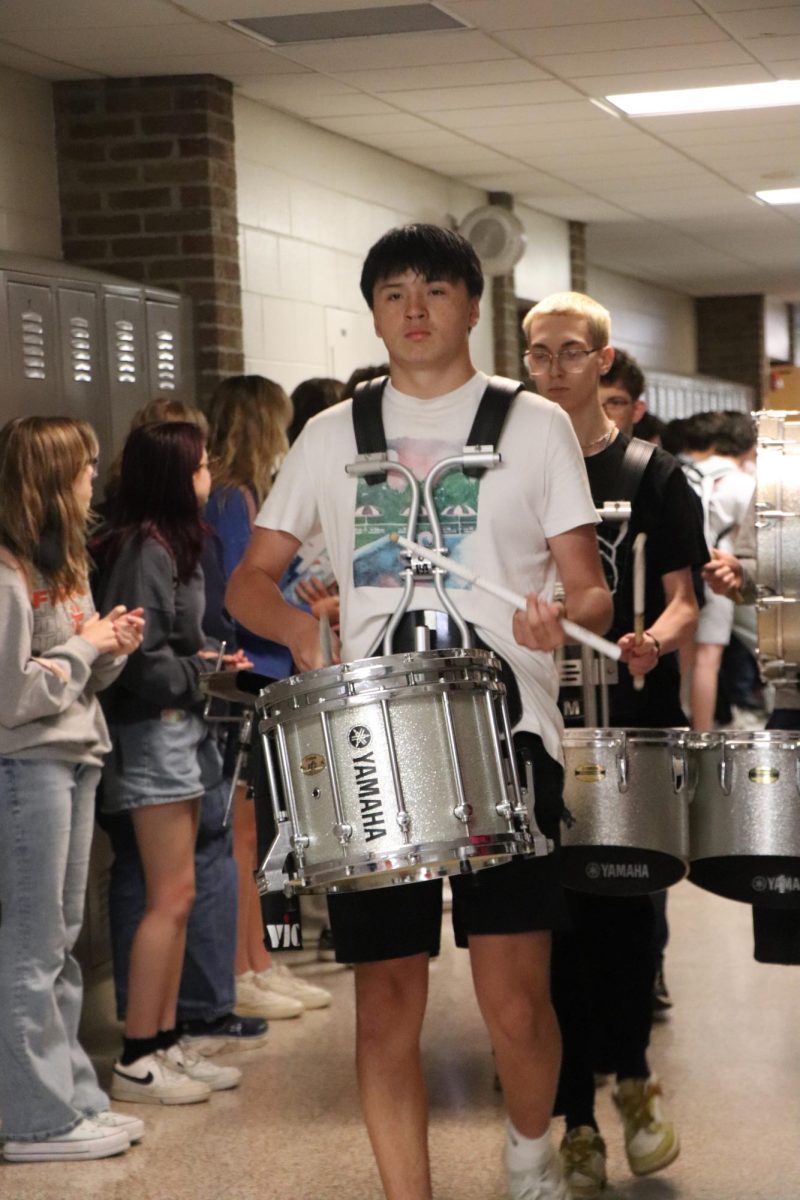 Walking, Junior Jonah Andrews leads the drumline. On May 30, the track team left for states. 