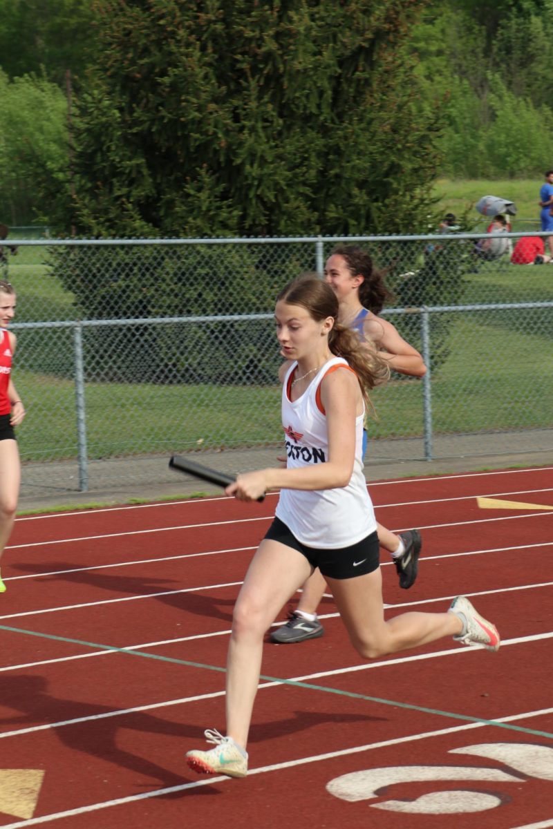 Running, Sophomore Peyton Thorp runs a 4 x 1 relay. On May 13, the Fenton track team goes against Linden.