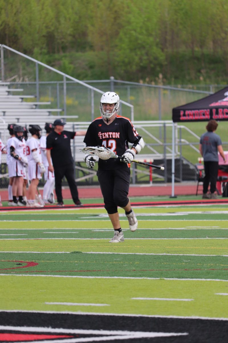Running, junior Lucas Hamlin jogs back to the goal after and intermission. On May 7, The JV boys lacrosse team played Linden and lost.