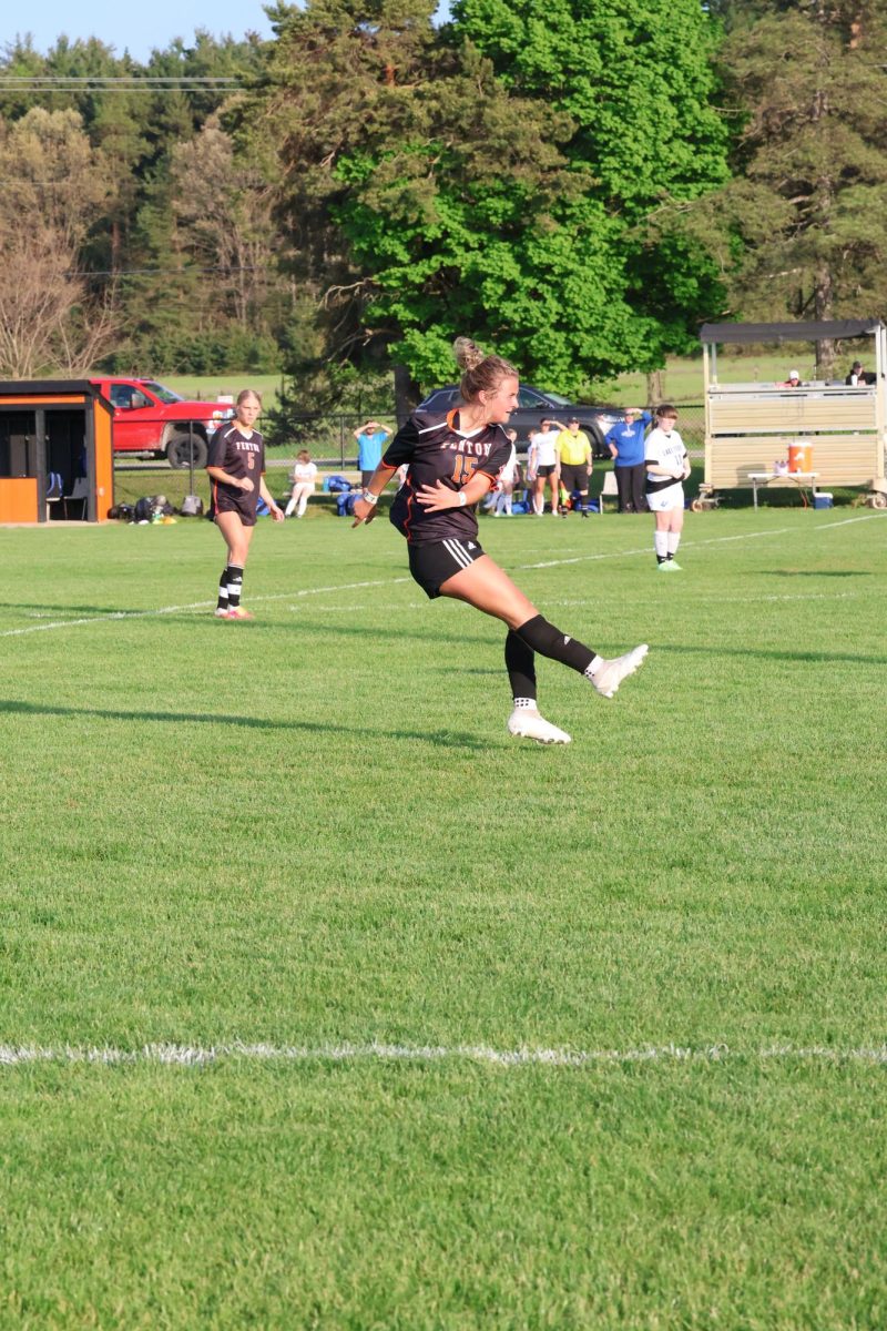 Kicking the ball, sophomore Bailey Britton attempts to score a goal. On May 5, the varsity soccer team played Lake Fenton losing 5-0.