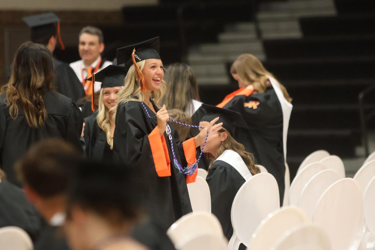 Smiling, senior Ellie Murry shows off her cord. On May 22, Fenton high school held a practice graduation for the seniors. 