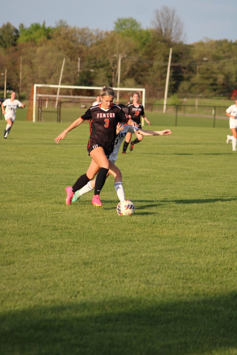 Kicking the ball, sophomore Lauren Chapple fights to score a goal. On May 2, the varsity soccer team played Lake Fenton losing, 5-0.