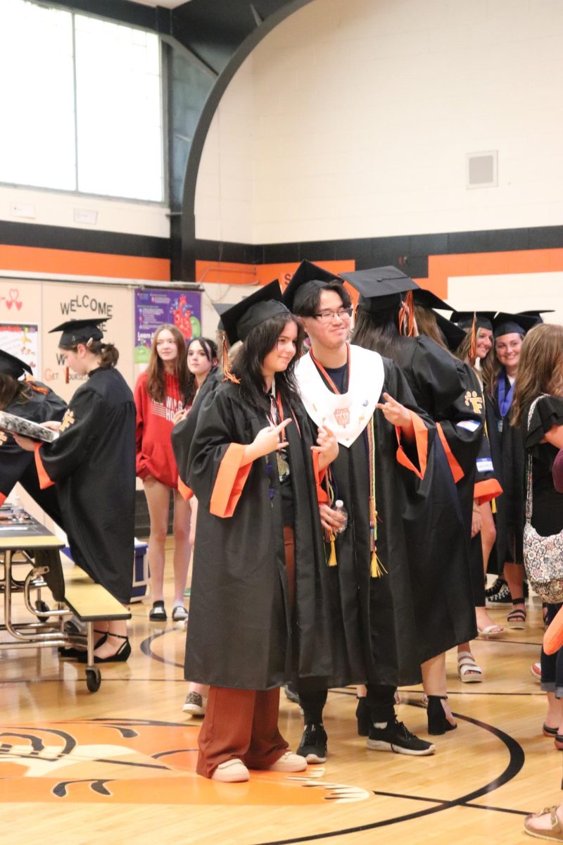 Posing, seniors Fox Gibson Dunlop and Landon Nguyen celebrate after their clapout through their elementary school. On May 22, all seniors who went to Tomek-Eastern Elementary School did one final walk through.