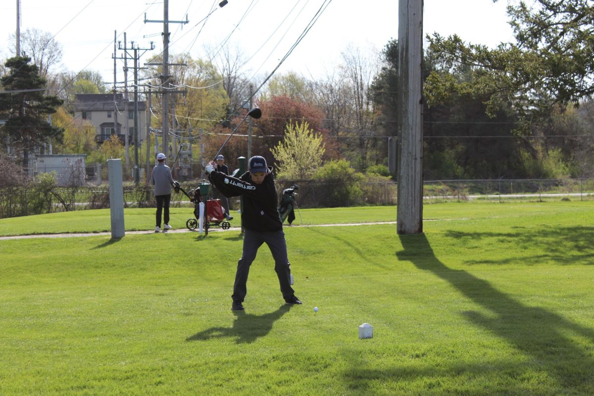 About to hit the ball, junior Levi Hudson swings his club. On Apr. 26, Fenton played against multiple opponents.