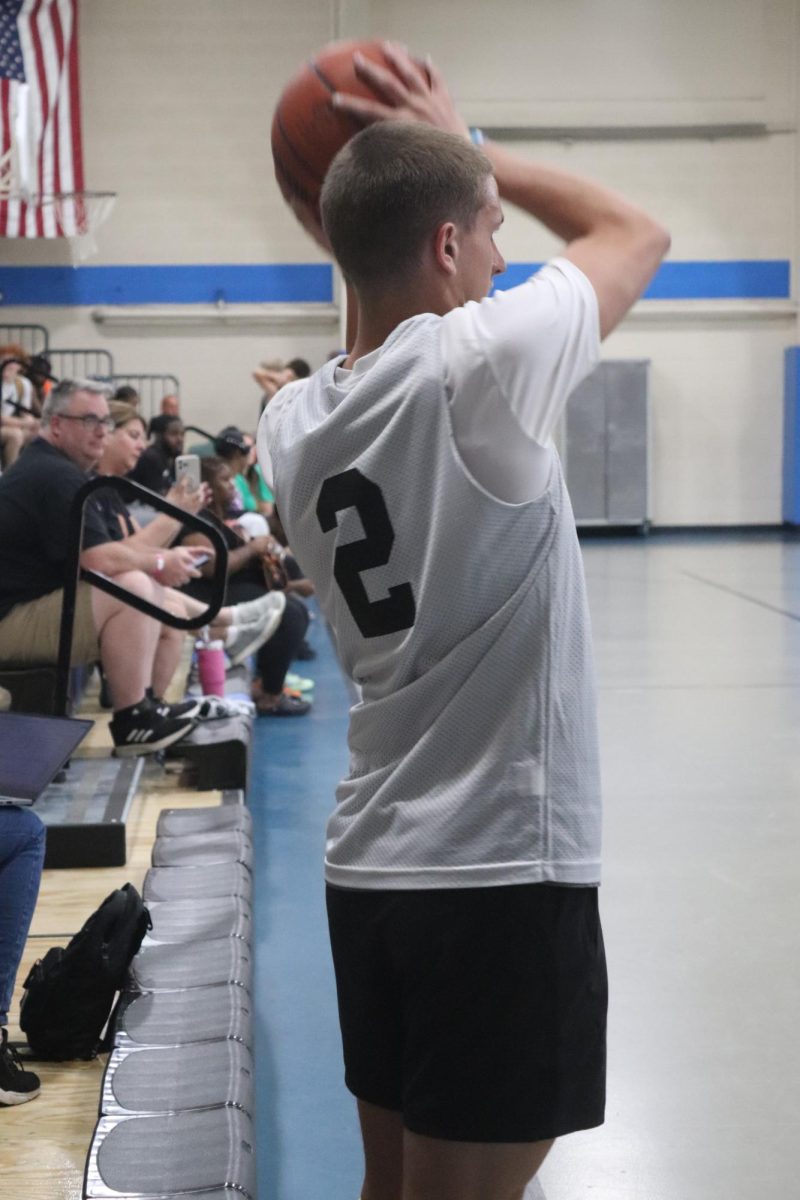 Throwing the ball in, senior Connor Mcdermott passes to his teammate. On June 19, the boy's varsity basketball team had a summer league game.  