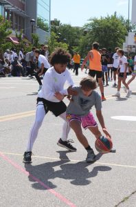 Watching the ball, freshman Cyson Lafreniere guards the basket. On June 11, students from FHS on the Michigan Elite basketball team compete in day 2 of a 3v3 Gus Macker tournament. 