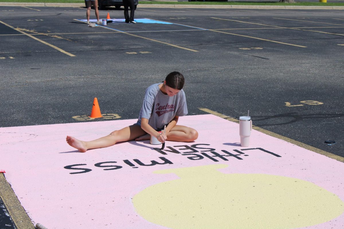 Painting, senior Adrianna Ayre makes her parking spot for her senior year. On Aug. 8, student council held parking lot painting for all the students.