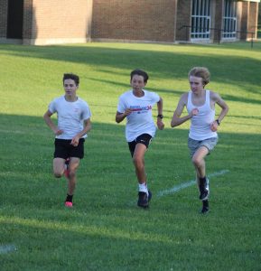 Running, freshman Gerard Gilmour participates in a race with his teammates. On Aug. 26, the cross country team held their annual two mile time trial.