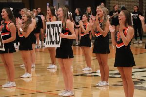 Chanting, senior Sophia Markley alongside the other Fenton cheerleaders do a cheer for the audience. On Aug. 21 all the FHS fall sports met in the gym for Meet the Team Night. 