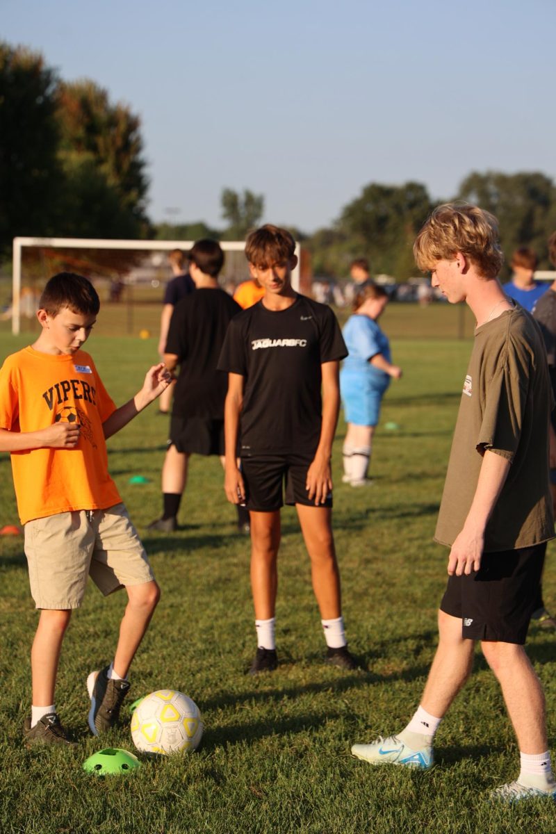 Passing the ball, junior Nate Roberts plays with his partner. On Sept. 17, the Fenton boys soccer practiced with the VIPers. 