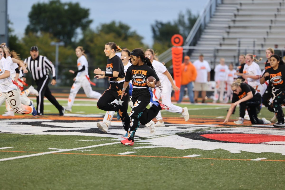 Sprinting towards the end zone, senior Rayn Rutley carries the ball down the field. On Sept.24, the seniors beat the juniors 
27-12 in the Powderpuff game.